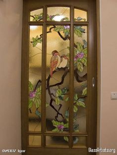 a stained glass door with a bird on it