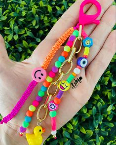 a person is holding some colorful items in their hand and it looks like they have been made out of beads