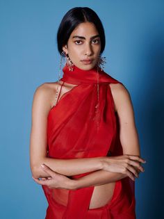 Editor's Note An easy to drape, transeasonal sari in ruby red that can seamlessly flow from your everyday outfitting to evenings of celebration. Play up the lightweight organza with a statement blouse or a tonal cape for a striking ensemble that commands attention. Note: Stitched blouse worn by model is for styling purposes only. The sari comes with unstitched blouse fabric. Fabric: Organza Color: Red Component: Sari and unstitched blouse piece. Occasion: Festive Size: Free size Sari length: 5.5 India Style Dress, Organza Sari, Urban Chic Outfits, India Style, Statement Blouse, Red Saree, Urban Chic, Blouse Length, Blouse Fabric