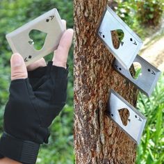 a person is holding up two pieces of metal on a tree