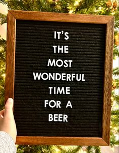 someone holding up a sign that says it's the most wonderful time for a beer