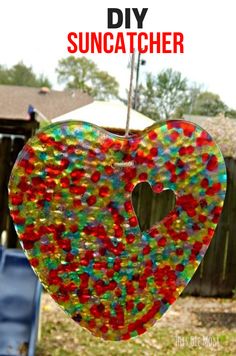 a heart shaped glass hanging from a string