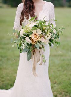 a woman holding a bouquet of flowers in her hands