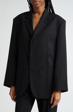 Never underestimate the statement an oversized jacket from Simon Portes Jacquemus can make. 32" length (size 42 FR) Hidden-button placket Notched lapels Chest welt pocket; front patch pockets; interior pocket Back vent Lined 53% viscose, 45% virgin wool, 2% elastane Dry clean Imported Designer Clothing Oversized Black Outerwear With Concealed Placket, Oversized Black Outerwear With Welt Pockets, Black Oversized Outerwear With Welt Pockets, Designer Oversized Black Outerwear, Designer Black Oversized Outerwear, Oversized Classic Long Blazer, Black Designer Oversized Outerwear, Designer Structured Workwear Outerwear, Oversized Black Wool Blazer