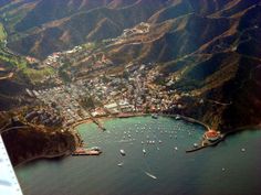 an aerial view of a harbor with boats in the water