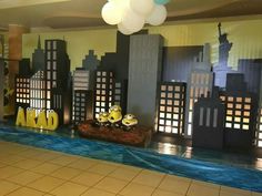 a room decorated with paper cutouts and balloons in the shape of cityscapes