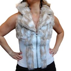 Stay warm and stylish with this Y2K faux fur fitted zipup vest by 26 International. The off-white color adds a touch of elegance to any casual occasion, while the sleeveless design makes it perfect for layering over long-sleeved tops. The big collar and classic fit give it a vintage feel that is both fashionable and cozy for the winter and fall seasons. Hand wash only to keep the polyester outer shell material looking its best. This vest is a must-have for any winter wardrobe, with its ski and winter themes making it a versatile piece that can be worn on many occasions. Look of rabbit fur but fake Nice and plush - soft to touch Tan brown hues in fur Ribbed knit waist with stretch Silver tone zipper with faux leather trim Light pink mark by zipper (very faint) Interior is lined Nice and war Trendy Winter Vest With Zipper Closure, Fitted Winter Vest With Zipper Closure, Trendy Fitted Winter Vest, Fitted Winter Vest With Faux Fur Trim, Fitted Faux Fur Vest With Faux Fur Lining, Trendy Fitted Vest With Zipper Closure, Fitted Sleeveless Faux Fur Vest, Fitted Sleeveless Vest With Faux Fur Lining, Fake Nice