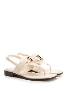 'Lula' thong sandal by Ferragamo, in white leather with double Gancini detail and flat sole. Composition: upper: 100% calf lining: 100% lamb sole: 100% bos taurus. Elegant Slingback Sandals With Leather Footbed For Beach, Elegant Beach Slingback Sandals With Leather Footbed, Chic White Calf Leather Sandals, White Leather Footbed Slingback Sandals, Elegant T-strap Sandals With Leather Footbed, Elegant Toe Post Sandals With Leather Footbed, White Sandals With Leather Lining For Summer, White Leather-lined Sandals For Summer, Elegant White Sandals With Leather Footbed