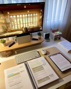 a desktop computer monitor sitting on top of a desk next to a keyboard and mouse