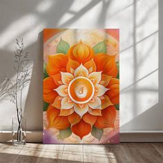 an orange and white flower with the letter b in it's center on a wooden floor