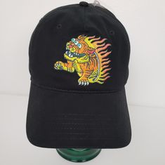 a black baseball cap with a tiger on it's front and flames across the bill