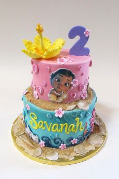 a two tiered cake with princess moan on top