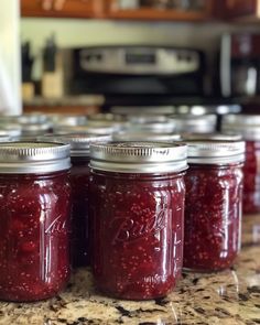 several jars filled with jam sitting on top of a counter