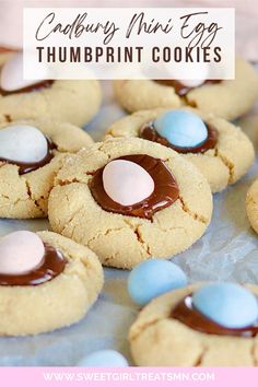 These Cadbury Mini Egg Thumbprint Cookies have a peanut butter cookie base with a thumbprint of chocolate ganache and a cadbury mini egg! Try these cadbury cookies, mini egg cookies, peanut butter thumbprint cookies, cadbury mini egg cookies, Easter cookies today! Cadbury Mini Egg Recipes, Butter Thumbprint Cookies, Mini Egg Cookies, Peanut Butter Thumbprint Cookies, Easter Baking Recipes, Mini Eggs Cookies