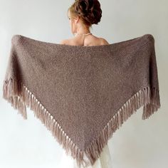 Elevate your style at winter weddings or evening events with the exquisite hand-knitted triangular taupe shawl. This versatile brown wrap piece not only complements any outfit but also provides warmth and protection from the chilly weather throughout fall, winter, and spring. Moreover, these cover up's make an excellent bridesmaid gift. MATERİAL:  Very soft, fuzzy and warm yarn. it is not itchy at all. 10% mohair, 10% wool, 80% premium acrylic-Polyamid,  MEASUREMENTS (Average): Length: 78'' (200 Winter Wedding Shawl, Bridesmaid Shawl, Bridal Cover Up, Bridal Shawl, Bridal Wrap, Fairy Wedding, Knit Wrap, Wedding Shawl, Wool Shawl