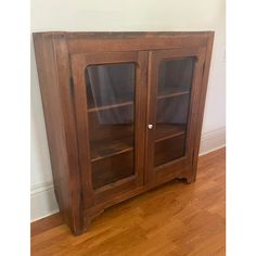 a wooden cabinet sitting on top of a hard wood floor