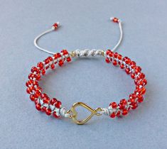 Red Seed Bead Heart Bracelet, Valentines Day Bracelet, Tiny Macrame Bracelet, Gift For Her The Bracelet is made by me with seed beads in red color, gold tone metal heart and light grey synthetic satin cord. ❥It is perfect as a gift to a friend or someone you love. SIZES: --------- Metal heart: 15 mm x 9 mm Width of Bracelet: 6 mm Synthetic Satin Cord: 0.9 mm Seed Beads: 2 mm Adjustable size in length with a sliding spiral macrame knot. Expands from 15 to 26 cm. Let me know if you need a differen Tiny Macrame, Seed Bead Heart, Valentines Day Bracelet, Spiral Macrame, Adjustable Beaded Bracelet, Bracelet Valentines, Bead Heart, Bracelet Friendship, Macrame Knot