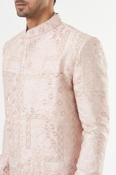 Blush pink sherwani in silk base with floral embroidery. Comes with a pant. - Aza Fashions Formal Pink Kurta With Naqshi Detailing, Pink Traditional Naqshi Sherwani, Designer Pink Kurta With Resham Embroidery, Pink Long Sleeve Sherwani With Dabka Work, Pink Bandhgala With Dabka Work, Pink Bandhgala With Chikankari Embroidery, Formal Pink Bandhgala With Intricate Embroidery, Pink Resham Embroidered Bandhgala For Formal Occasions, Pink Embroidered Nehru Jacket Kurta