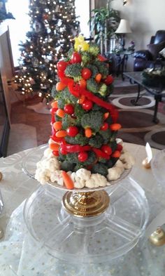 a christmas tree made out of veggies on top of a glass plate