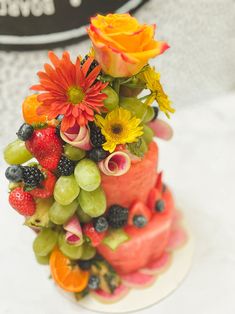 a cake made out of fruit and flowers