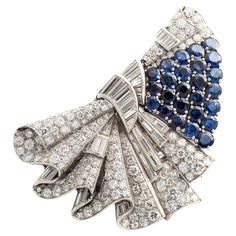 Art Deco Brooch Double Clip Sapphire and Diamond on platinum and white gold. Circa 1935. The Art Deco era stands as an eternal source of inspiration. The Art Deco Brooch Double Clip, adorned with resplendent sapphires and diamonds, is a true gem that transcends time. Its geometric precision, bold lines, and dazzling gemstones. A symphony of sapphires and diamonds set in platinum, it is a harmonious blend of color and light, radiating elegance and sophistication. The double clip design offers ver Platinum White Gold Fine Jewelry Brooch, Art Deco White Gold Brooch In Platinum, Art Deco Platinum Brooches In White Gold, Art Deco White Gold Platinum Brooches, Art Deco Jewelry Vintage, Art Jewelry Design, Clip Design, Art Deco Brooch, Art Deco Pattern