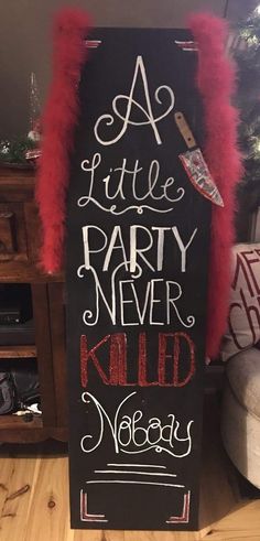 a little party never killed vodka sign with red feathers on the bottom and black background