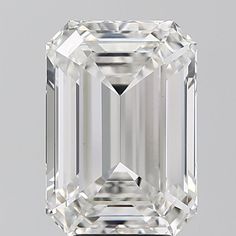 an emerald cut diamond on a gray background