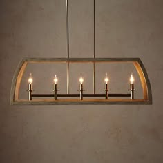 a chandelier with five lit candles hanging from it's center and four lights on each end