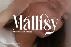 a woman laying on top of a bed next to a white wall with the word'mall