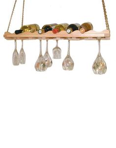 a wooden shelf with wine glasses hanging from it