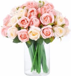 a vase filled with pink and white roses