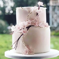 a white cake with pink flowers on top