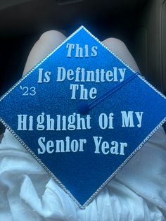 a blue graduation cap that says, this is definitely the highlight of my senior year