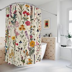 the shower curtain is decorated with colorful flowers