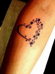 a heart shaped tattoo with stars on it