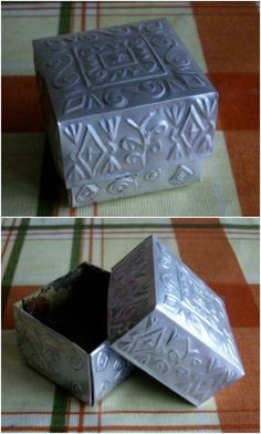 two silver boxes sitting on top of a checkered table cloth