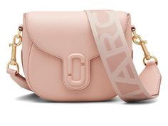 Marc Jacobs The Saddle Bag - Cross Body Handbags : Rose : Viet Nam The Saddle Bag Refresh your stylish look carrying the Marc Jacobs The Saddle Bag. Crafted from leather, this bag features magnetic closure, detachable and adjustable crossbody strap, and one zippered interior pocket. Brand logo on the front. Polyester lining. Imported. Chic Pink Saddle Bag For Everyday Use, Pink Satchel Saddle Bag With Detachable Strap, Pink Saddle Bag With Detachable Strap Satchel, Pink Saddle Bag With Detachable Strap, Pink Crossbody Saddle Bag With Detachable Strap, Designer Blush Bag With Detachable Strap, Saddle Bag, Crossbody Strap, Magnetic Closure