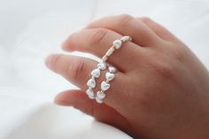 Beautiful stretchy ring with freshwater pearl with heart form and gold or silver beads. Perfect stackable ring and the most trendy ring of the season. Very comfortable and easy to wear. Dainty White Adjustable Heart Ring, White Beaded Pearl Ring, White Pearl Charm Ring For Promise, White Pearl Rings With Round Beads, Adjustable White Heart Ring, Dainty White Heart Ring For Gift, Dainty White Heart Ring As Gift, Dainty White Heart Ring Gift, Adjustable White Pearl Ring With Pearl Charm