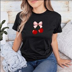 This charming t-shirt features an adorable design of two vibrant red cherries adorned with a lovely pink bow. The playful combination of the red cherries and pink bow creates a fun and eye-catching look that is perfect for adding a touch of sweetness to your outfit. Made from soft and comfortable fabric, this cherry t-shirt not only looks cute but also feels great to wear all day long. Whether you're out for a casual stroll, hanging out with friends, or simply relaxing at home, this t-shirt is a delightful choice. Embrace a playful and stylish vibe with this cherry-themed t-shirt that will surely turn heads wherever you go. Add a pop of color and a hint of whimsy to your wardrobe with this adorable cherry t-shirt that celebrates the beauty of nature in a fun and fashionable way. .: The tea Fruit Shirt, Bow Shirt, Bow Shirts, Cute Fruit, Graphic Tees Women, Pink Bow, Vibrant Red, Halloween Shopping, Graphic Tee