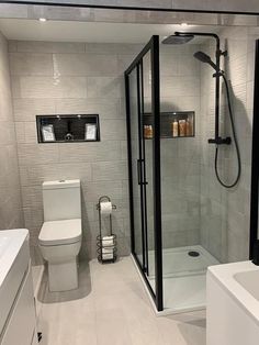 a bathroom with a shower, toilet and sink in it's center area is shown