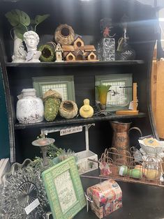 there are many items on the shelves in this room, including vases and boxes