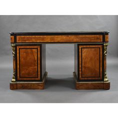 an antique desk with marble top and gold trimmings on the legs, inlaid to