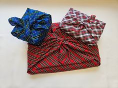 three different types of bow ties laying on top of each other, one red and one blue