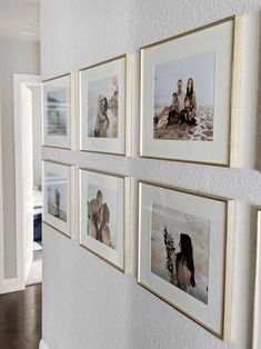 a wall with several pictures hanging on it