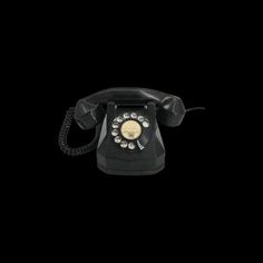 an old fashioned telephone is shown against a black background