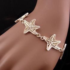 This beautiful never worn starfish bracelet would make a great gift for the ocean lover. IT is thick and well made and would be perfect for your favorite mermaid! 12-2-20 Starfish Charm Bracelet As A Gift, Starfish Charm Bracelet Gift, Ocean-inspired Bracelet With Starfish Charm, Starfish Charm Bracelet As Gift, Adjustable Starfish Charm Jewelry, Star-shaped Bracelet With Starfish Charm Gift, Ocean-inspired Starfish Charm Bracelet, Adjustable Silver Bracelet With Ocean-inspired Style, Adjustable Silver Bracelets With Ocean-inspired Style