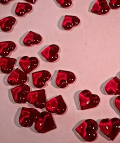 some red hearts are on a white surface