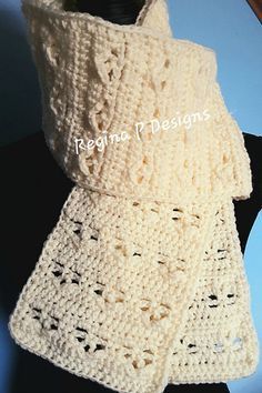 a white crocheted scarf on top of a mannequin