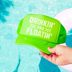 Get ready for summer fun with our vibrant "Drinkin' and Floatin'" neon trucker hats! Perfect for those sunny days on the water, these hats are sure to make a statement. Whether you're floating down the river, lounging by the pool, or just soaking up the sun, these hats are the perfect accessory to show off your laid-back, fun-loving style and they make a great gift! Features: - Bold white text with a distressed look that reads "Drinkin' and Floatin'" - Comfortable and breathable mesh back - Adjustable snapback closure for a perfect fit - Available in Neon Pink, Neon Green, and Neon Blue Care Instruction: - Spot clean with a damp cloth as needed. Floating Down The River, Lake Beach, Down The River, Pink Neon, Fun Loving, Spot Cleaner, Neon Blue, Beach Trip, Neon Green