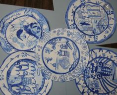 four blue and white plates sitting on top of a table